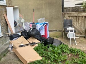 Mixed household waste including furniture, boxes and bags for collection in Penge