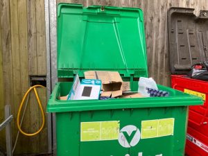 Commercial waste bins filled with black bags during collection service at Central Park, Dartford DA1