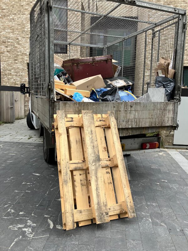 Junk Guy rubbish removal truck fully loaded with pallets and waste during clearance service in Greenwich SE10