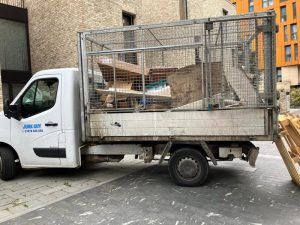 Junk Guy rubbish removal truck fully loaded with pallets and waste during clearance service in Greenwich SE10