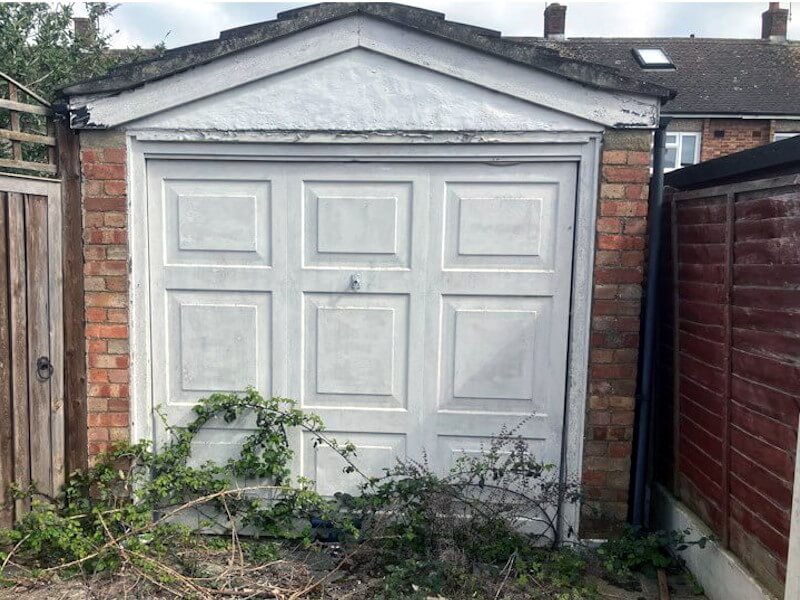 Professional brick garage demolition showing systematic dismantling by Junk Guy certified demolition team