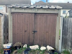 Concrete garage demolition using specialized equipment for safe sectional concrete structure dismantling