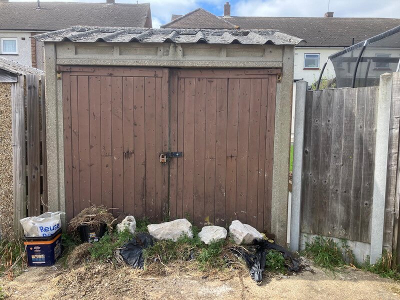 Concrete panel garage removal showing specialized demolition of prefabricated concrete garage