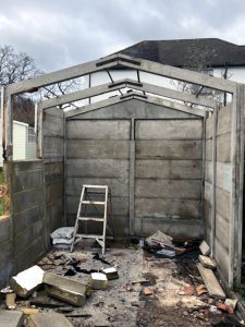 Garage demolition dismantling process showing systematic structural breakdown by professional team