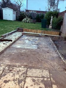 Garage demolition completion showing clean site with preserved concrete base foundation