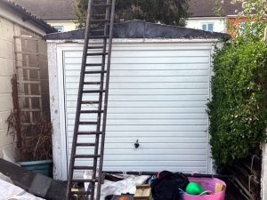 Active garage demolition work in The Rodings Upminster showing dismantling progress