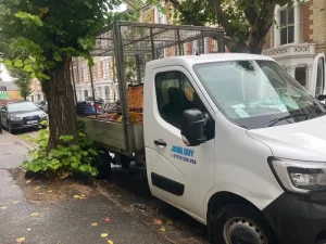 Junk Guy professional shed removal truck parked on Islington street with Victorian houses