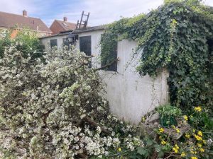 Old garage removal service showing demolition of deteriorated garage structure