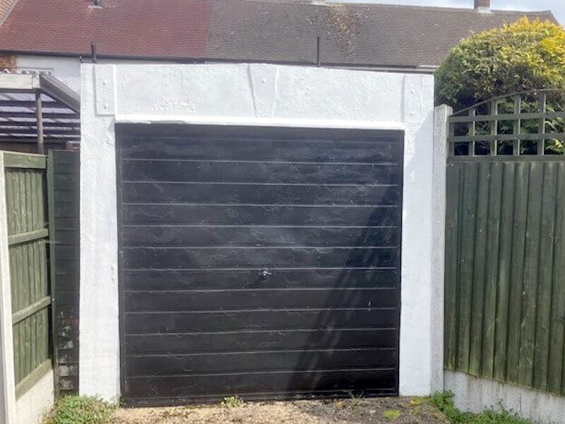 Single garage demolition showing compact structure dismantling by professional demolition team