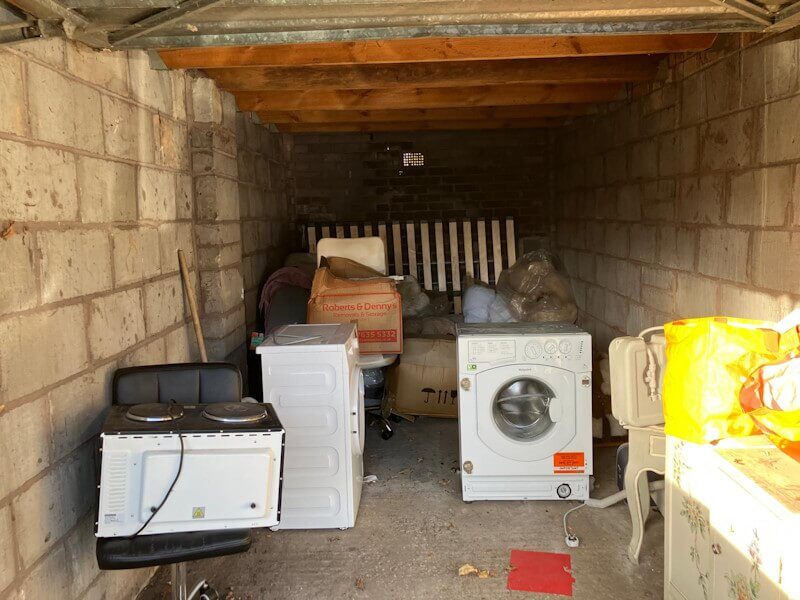 Washing machine and cooker removal from residential garage in London - professional multiple appliance disposal by Junk Guy®