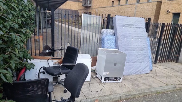 Residential estate entrance gate before rubbish removal — Elephant and Castle SE1